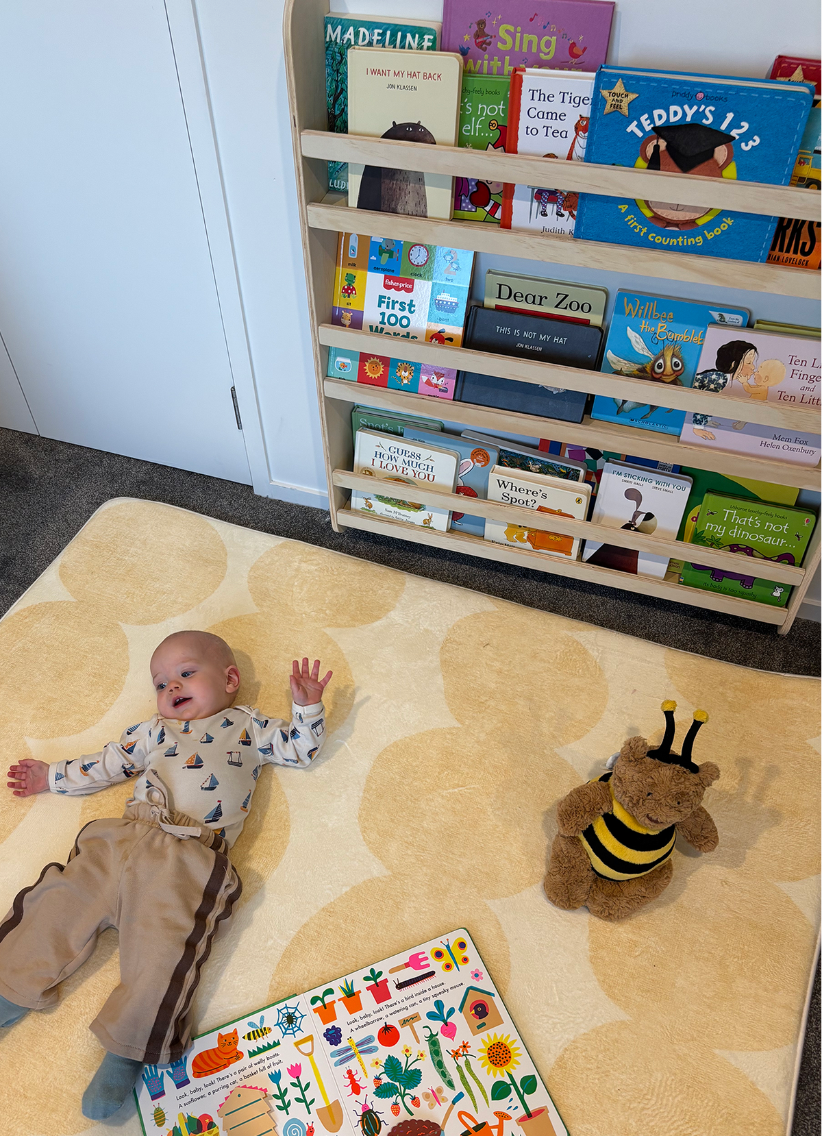 Children choosing books from a front-facing bookshelf