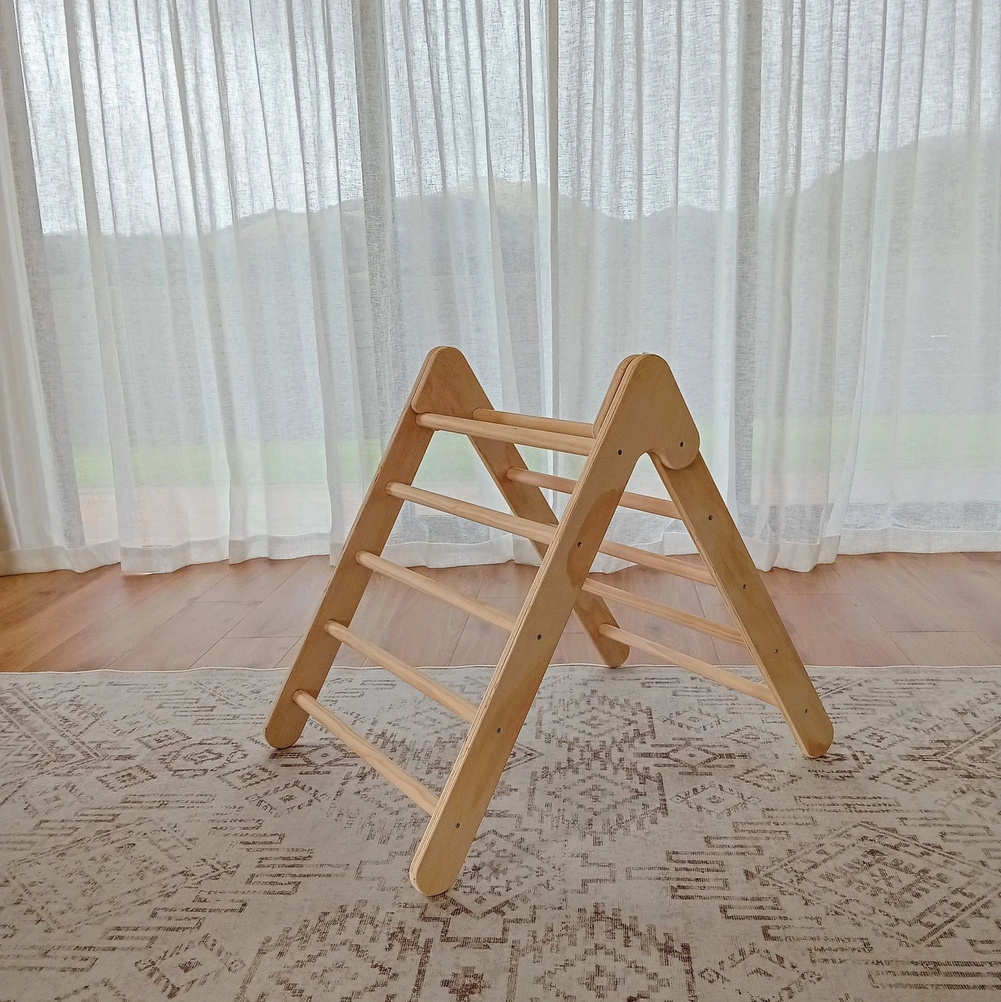Side view of a Montessori Pikler Triangle for active play