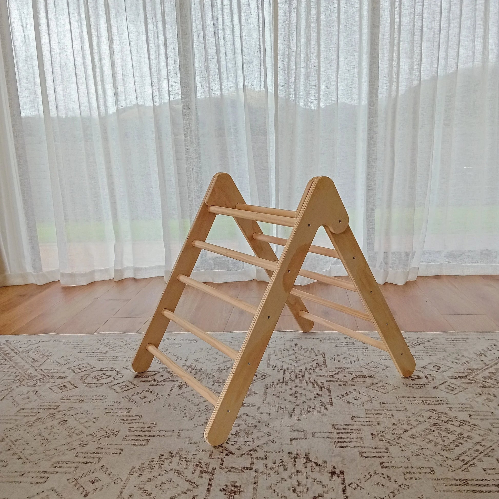 Side view of a Montessori Pikler Triangle for active play