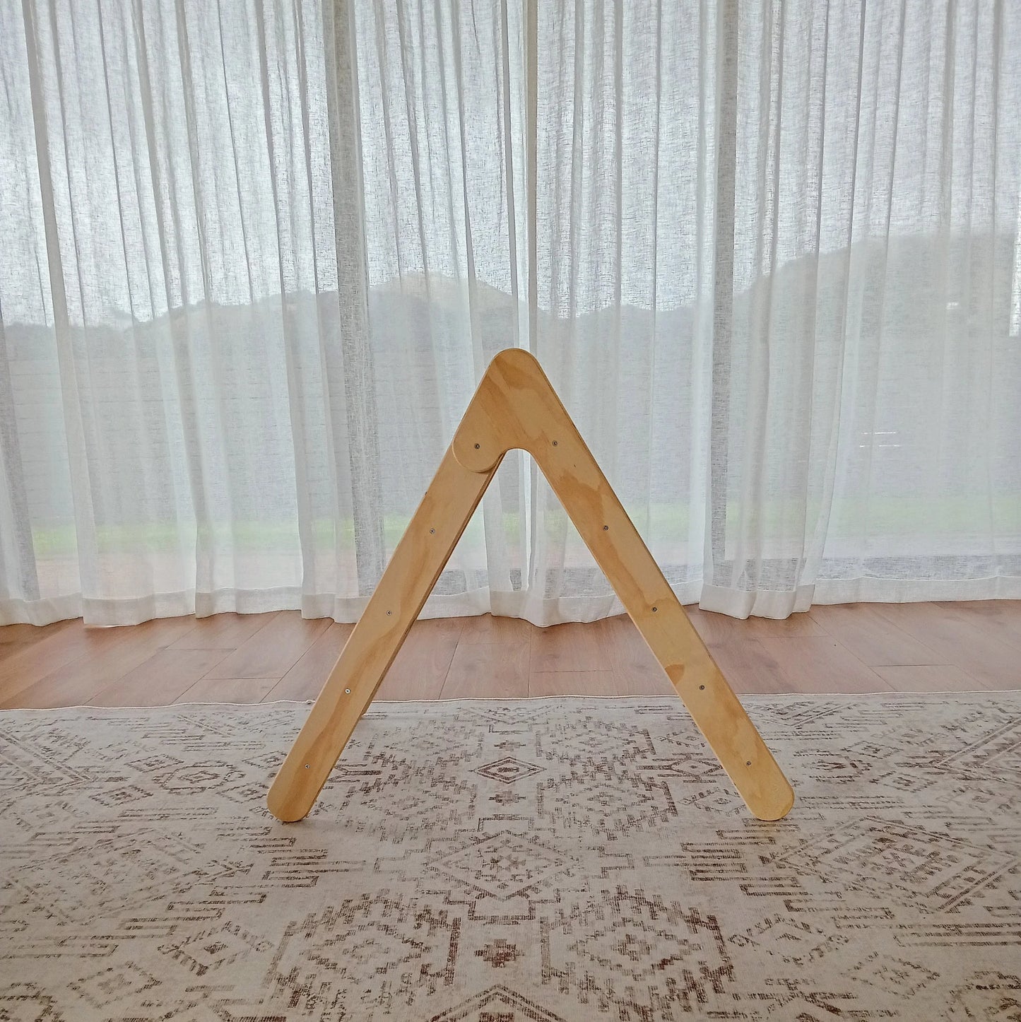 Side view of a Montessori Pikler Triangle for active play